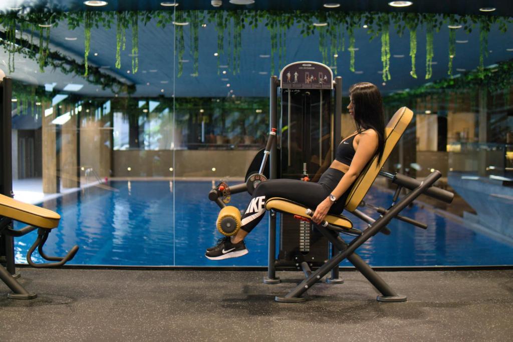 Select Hill Resort a woman sitting on a exercise machine