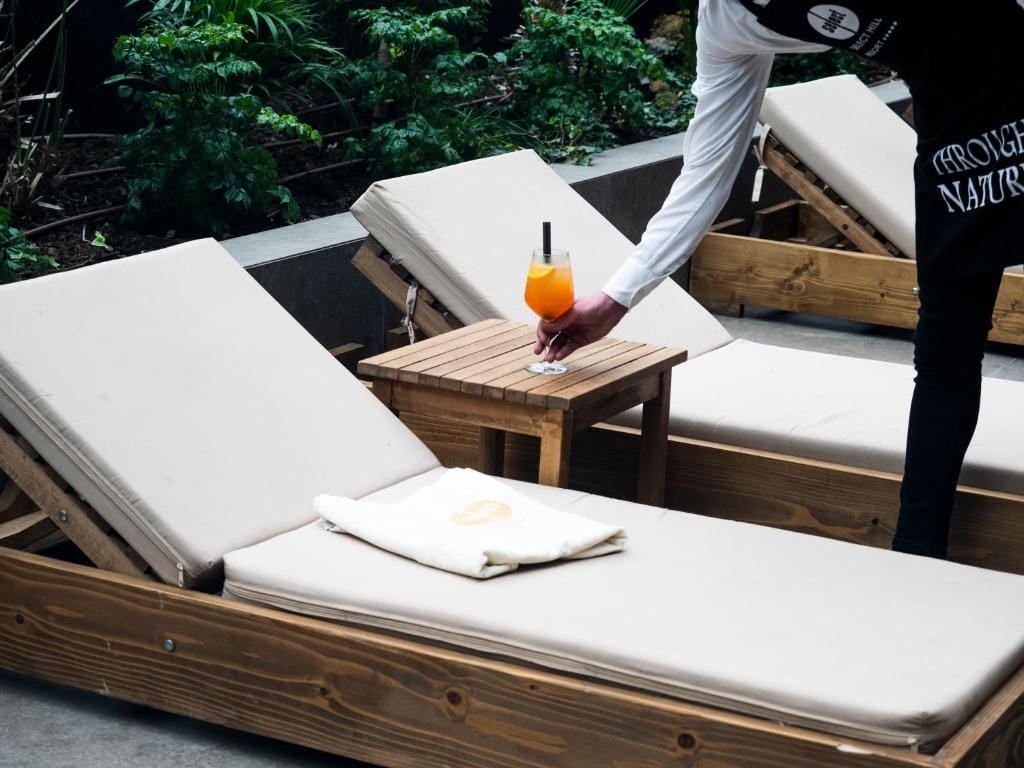 Select Hill Resort a person holding a drink