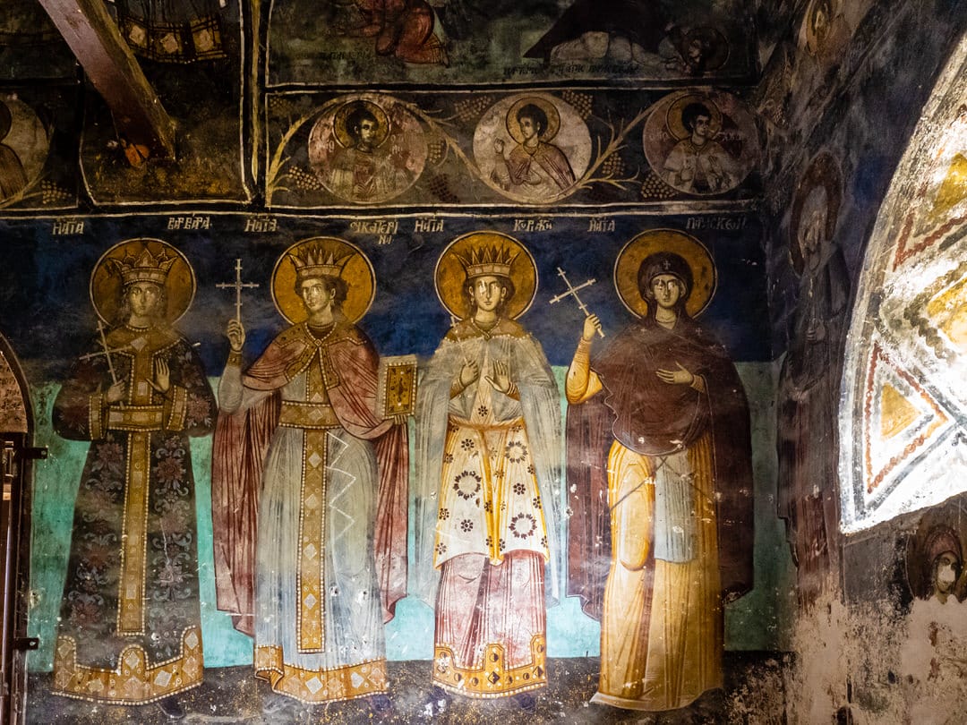 a Byzantine mural of people in a building Voskopoja